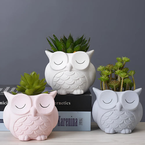 Handmade frosted ceramic flower pot with cartoon owl design, shown in light pink colour.