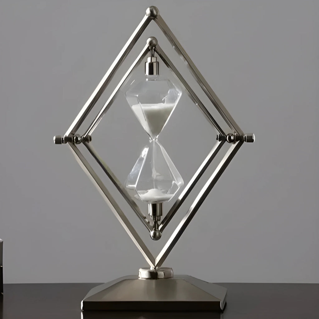 Modern zinc alloy hourglass timer on desk showing bronze frame with white sand.