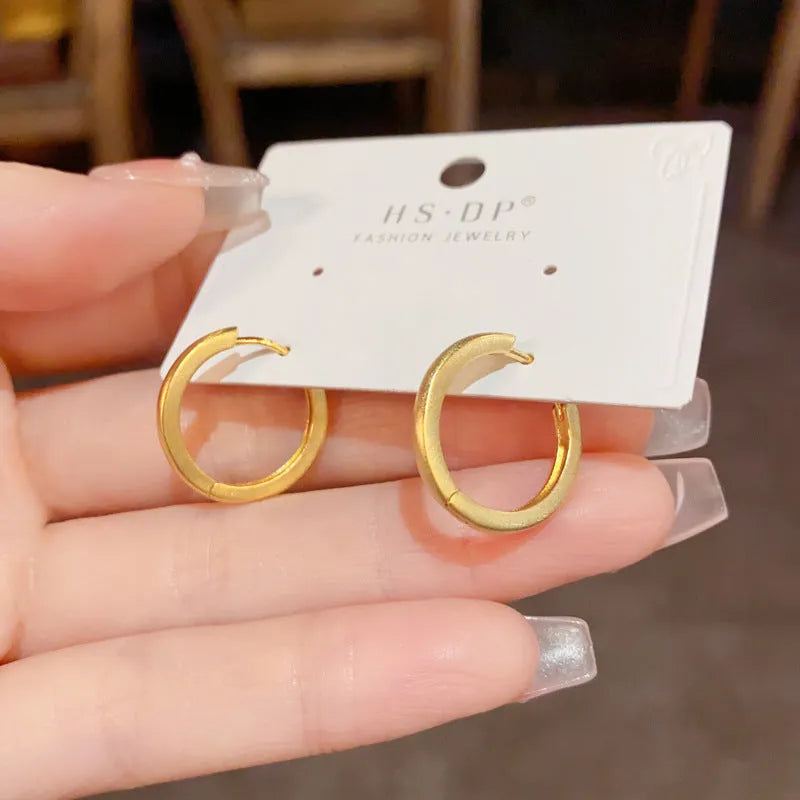 Geometric women's ear clips with gold plating and round eyelet design on copper material
