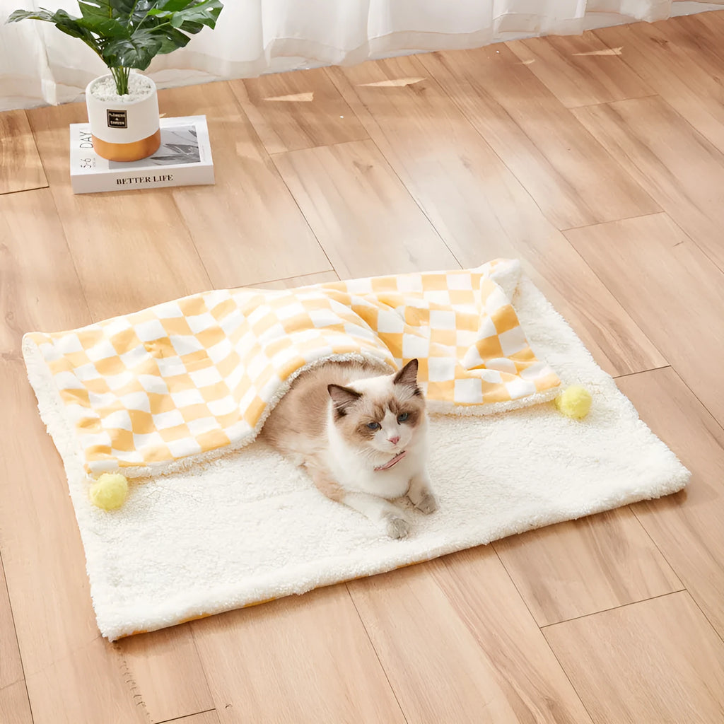 Green plaid pattern pet blanket with soft fleece texture on sofa