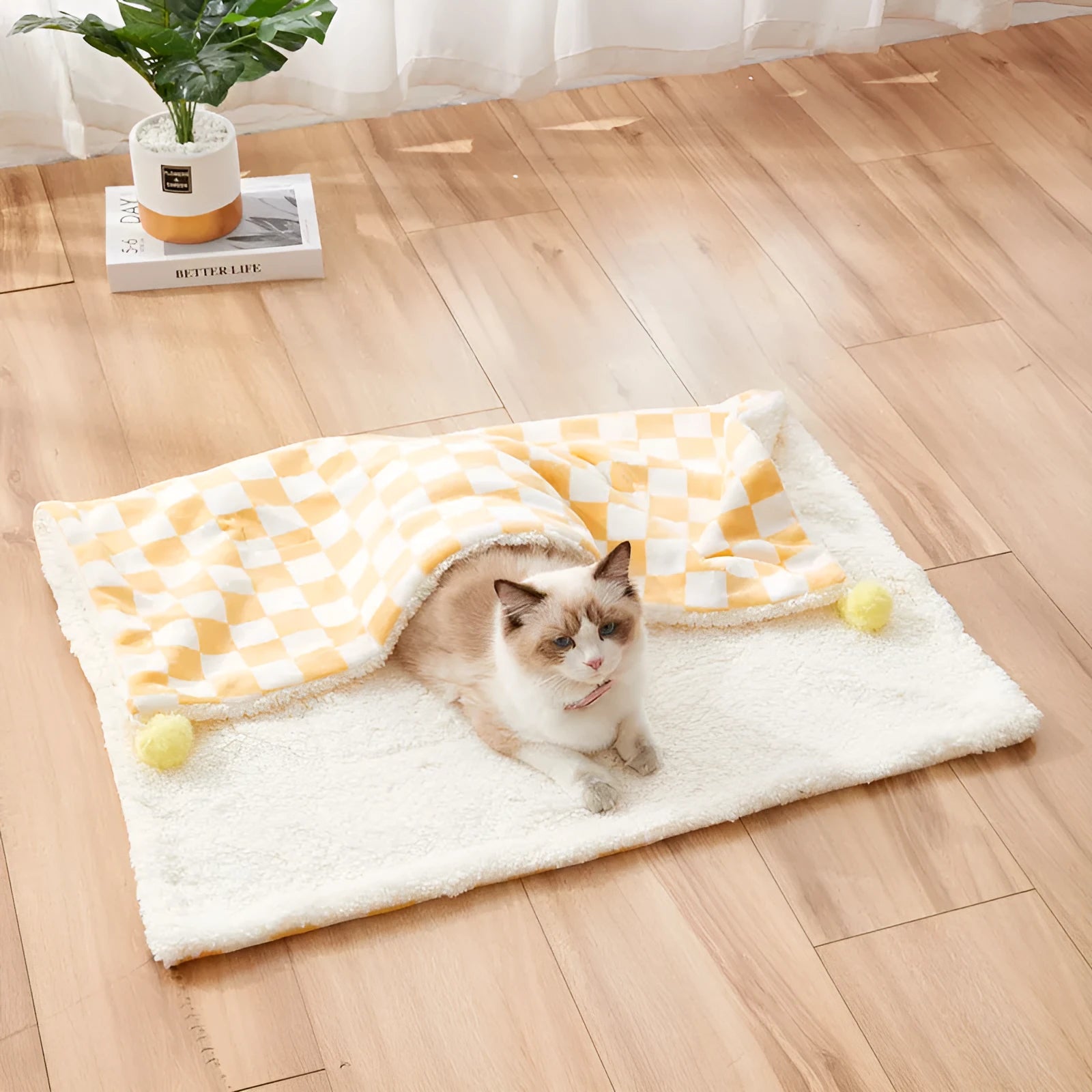 Green plaid pattern pet blanket with soft fleece texture on sofa