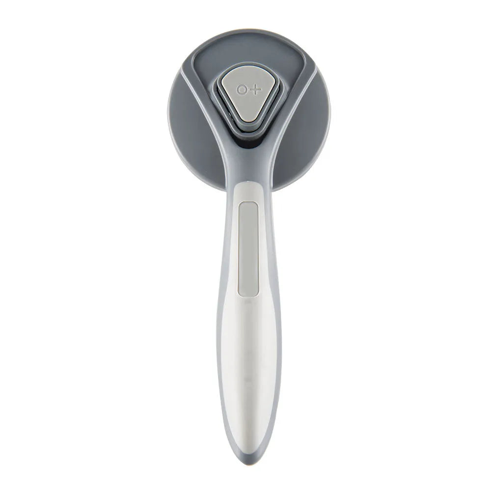 Grey, green, and pink self-cleaning slicker brush for cats and dogs with a non-slip handle.