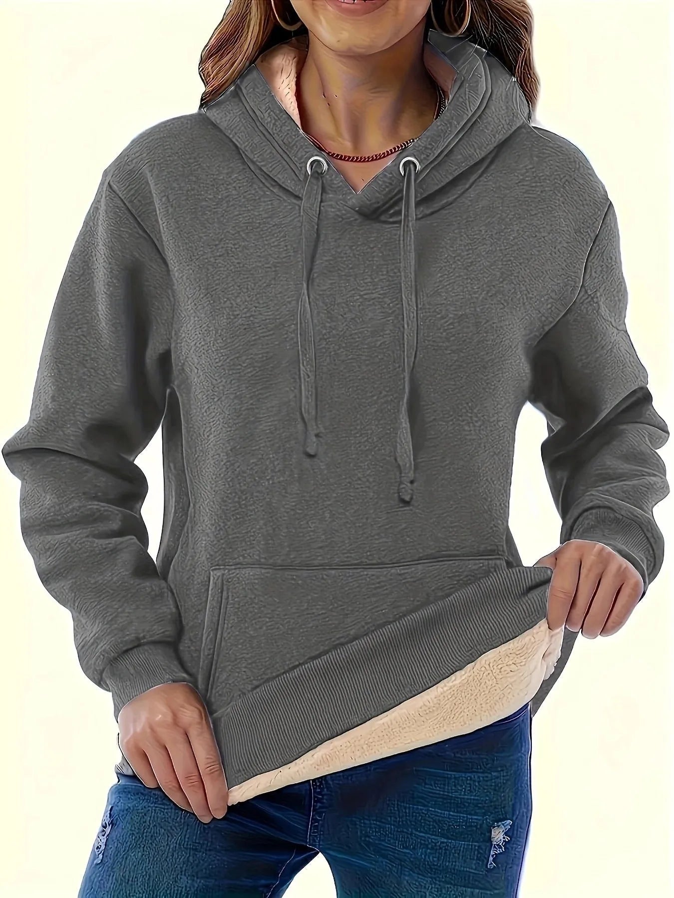 Women's loose grey hooded sweater with a 3D textured pattern on the front.