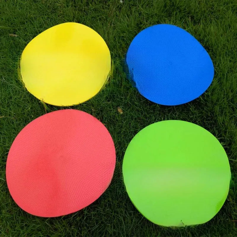 Yellow TPE football training target disc on grass, 23cm diameter flat landmark pad