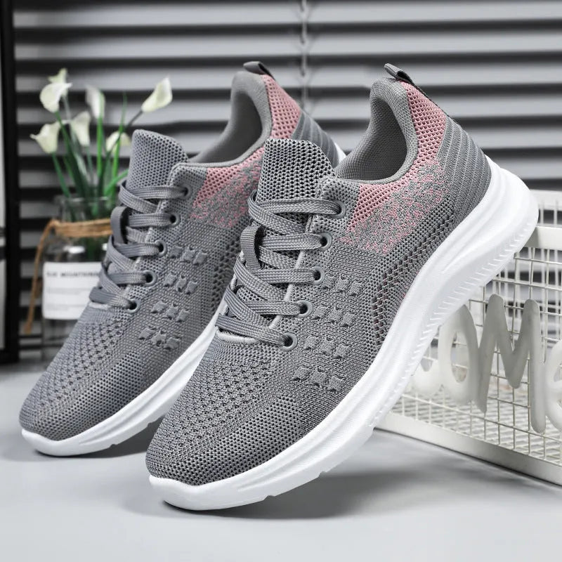 Women's low-top lace-up sneakers in black with breathable mesh upper and soft PVC sole