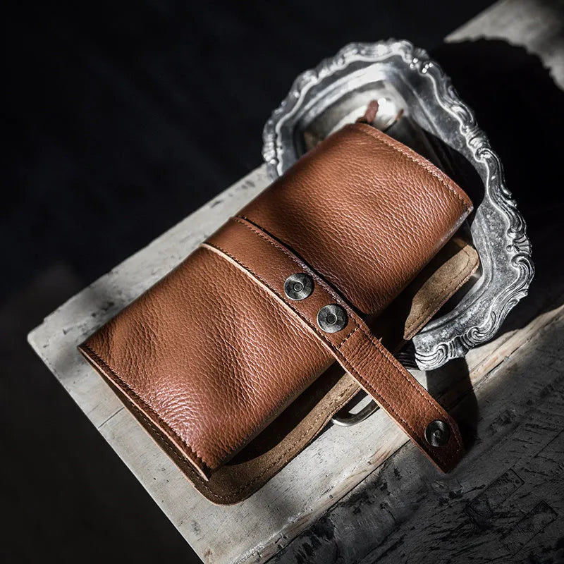 Handmade dark brown leather bifold wallet with tape extraction closure showing 20cm width