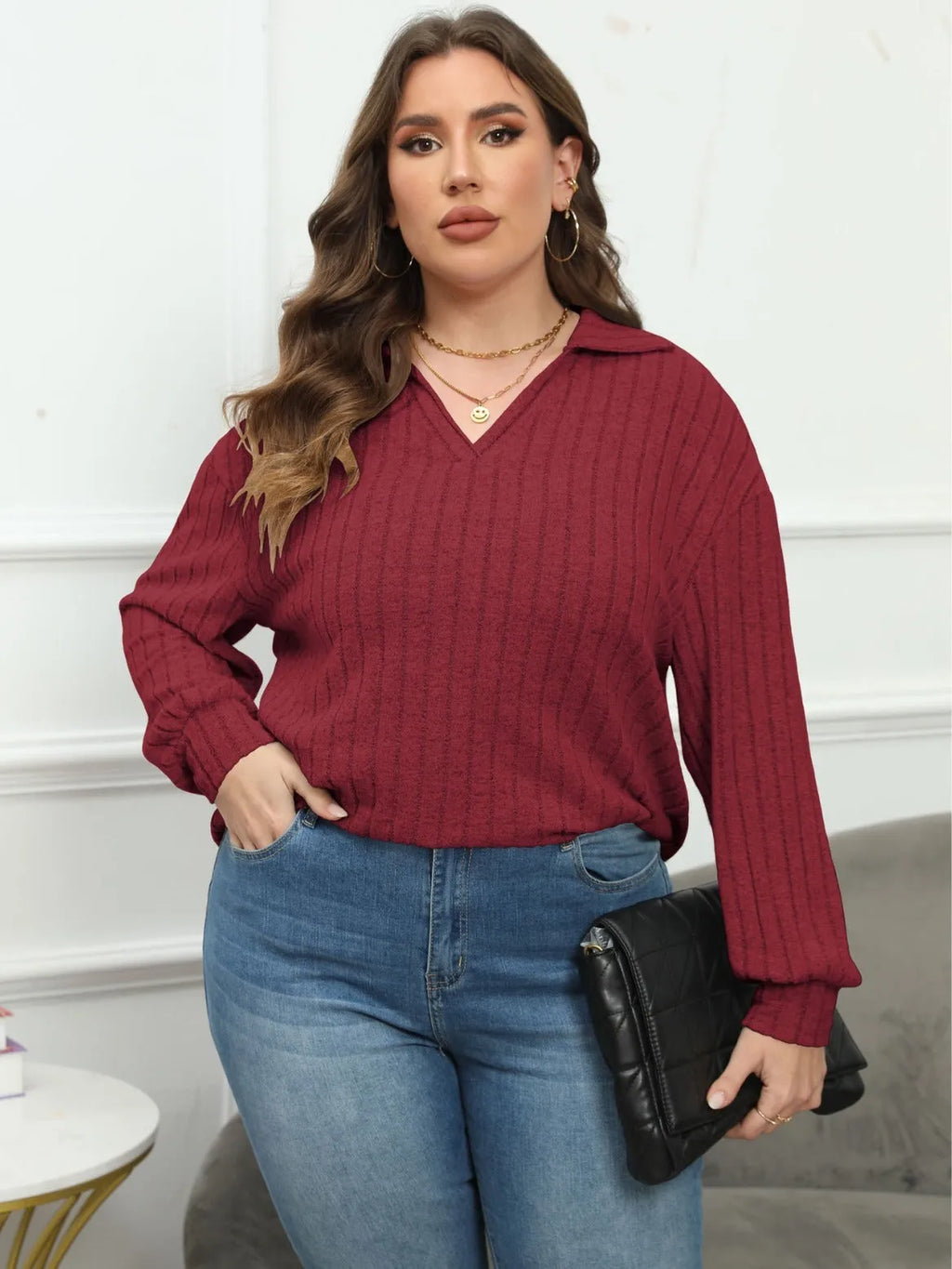 Plus size woman wearing a grey polo collar fleece pullover blouse with lantern sleeves.