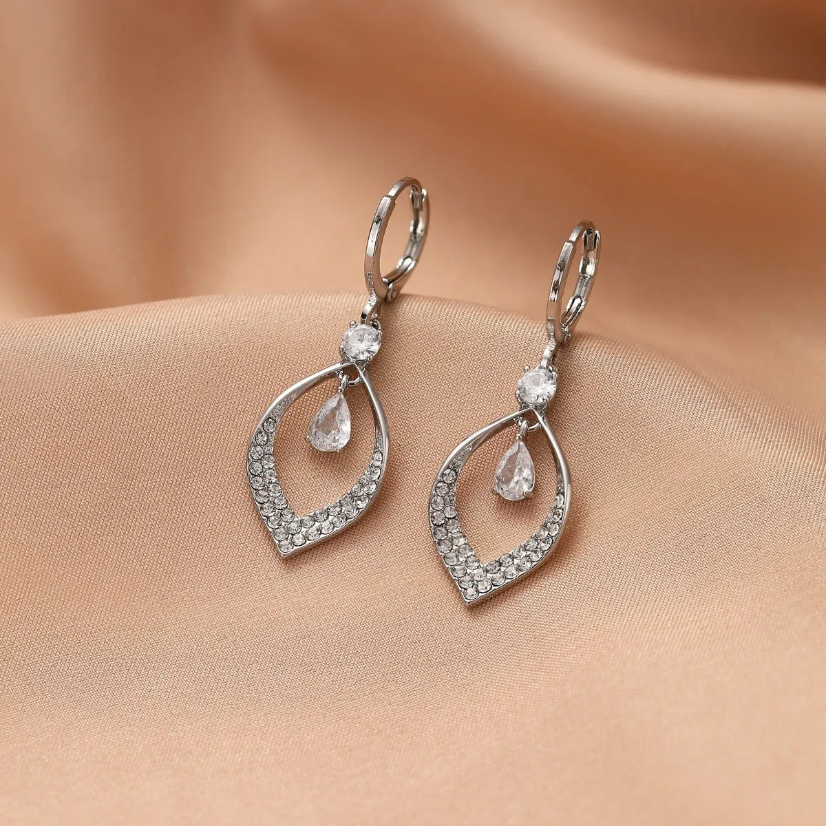 Copper electroplated women's earrings with water drop tassel design and gold or silver buckles
