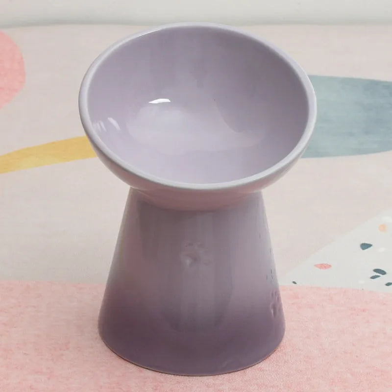 A white ceramic pet bowl with a high foot and raised neck protector to prevent tipping.