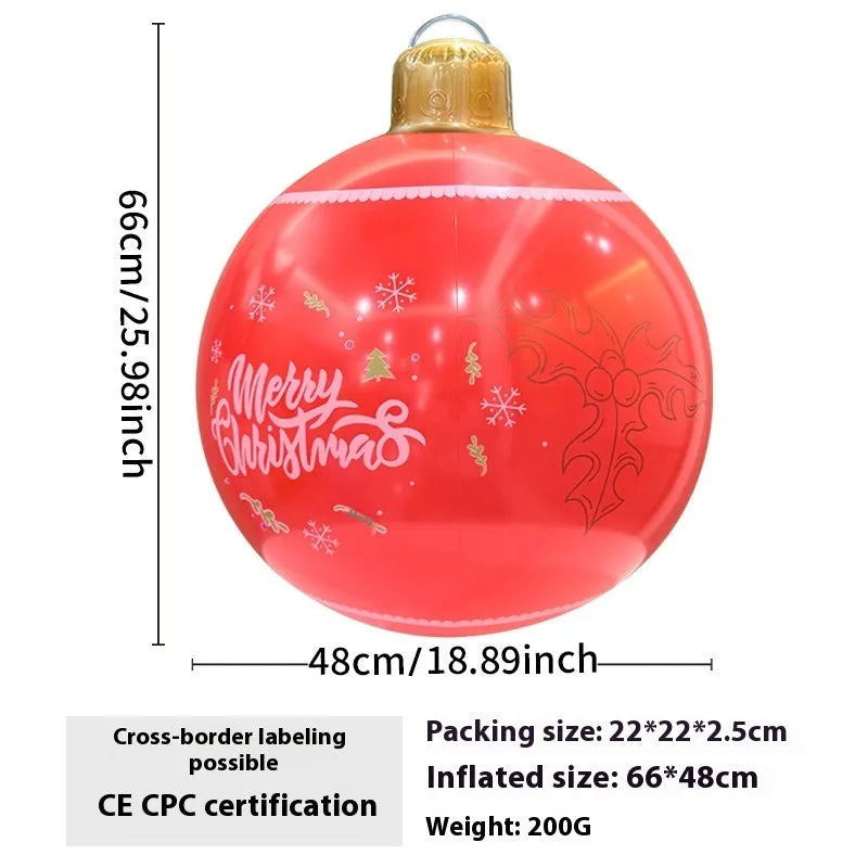 Large red inflatable Christmas ball with snowflake design and LED lights in outdoor garden setting