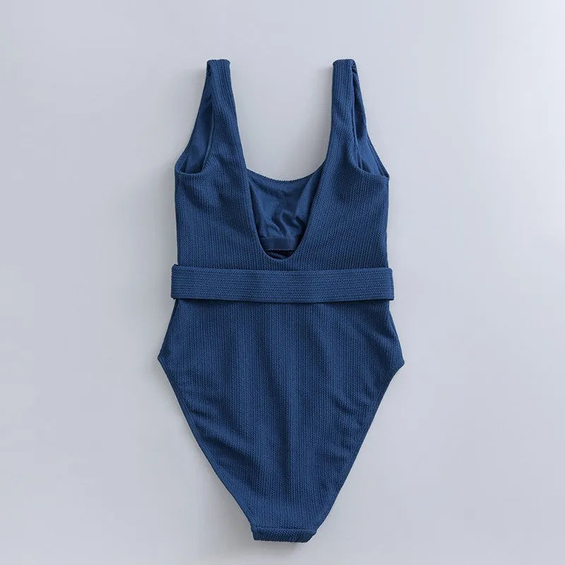 Navy blue women's one-piece swimsuit with slimming triangle silhouette and chest pads for swimming