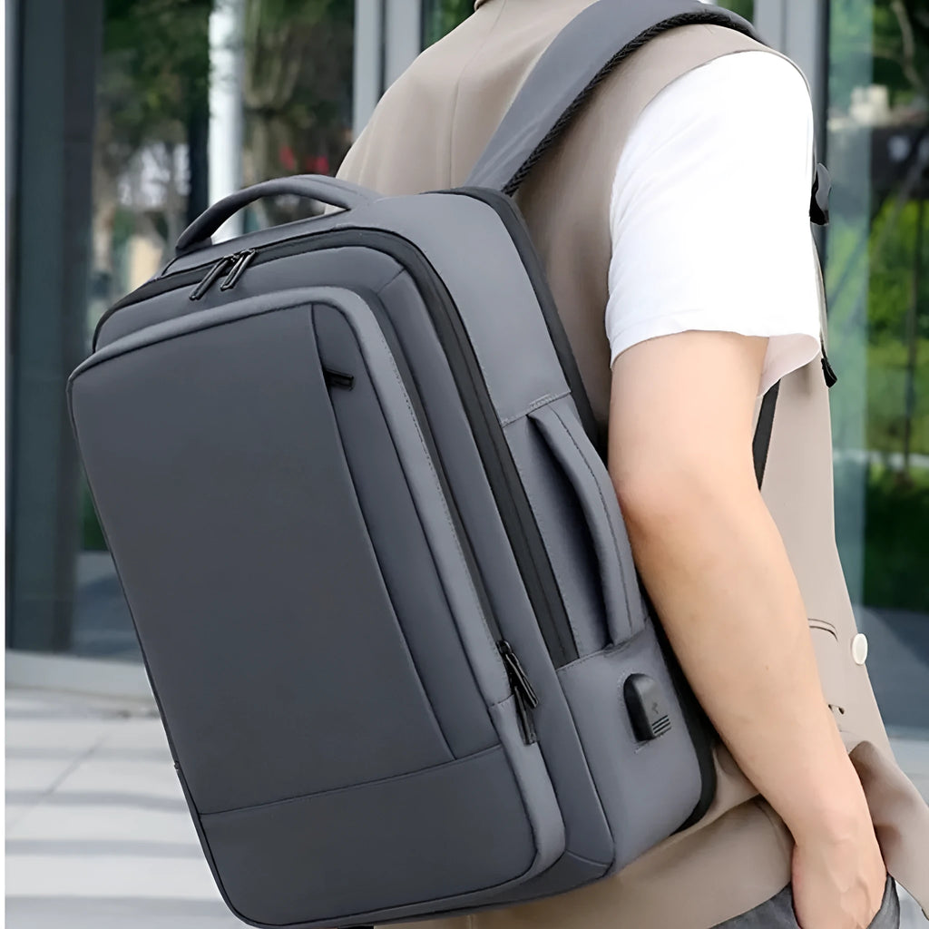 Black large capacity waterproof Oxford backpack with curved shoulder strap and hand carry handle.
