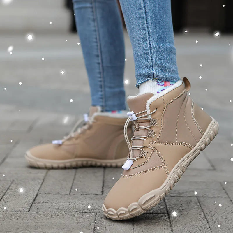 Black waterproof snow boots with lace-up front, fleece lining, and rubber sole on a winter background
