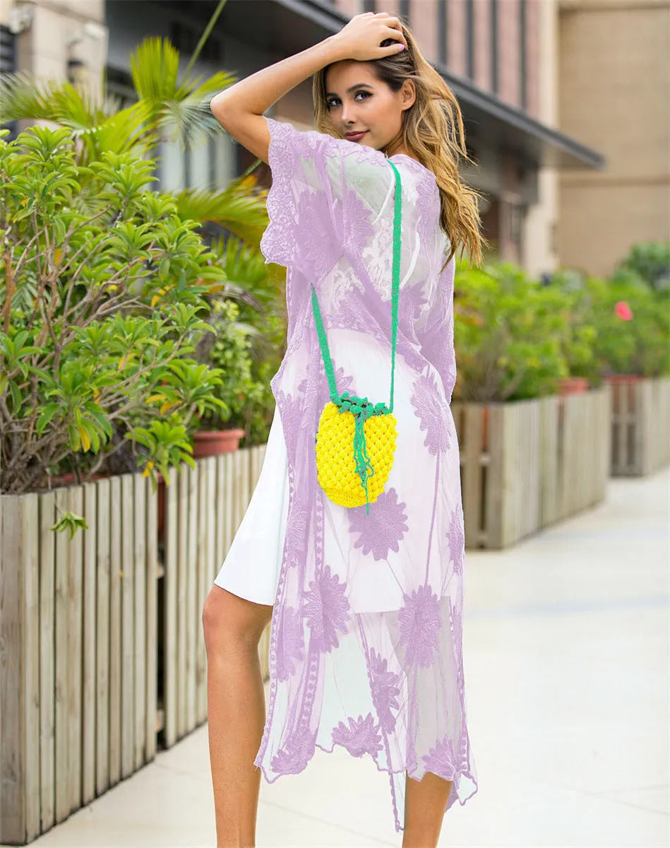 Light purple lace embroidered dress worn as a beach cover-up cardigan.