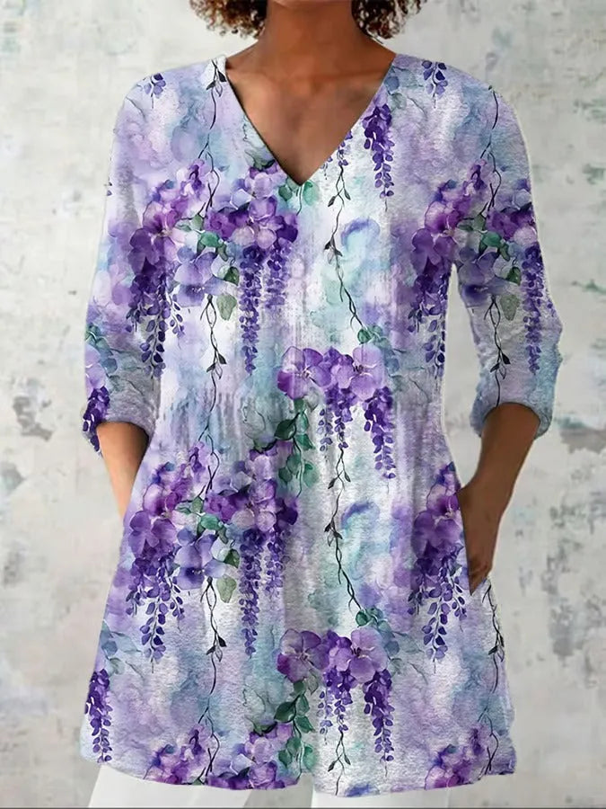 Woman wearing a retro slim fit, digitally printed long-sleeved top in a floral design.