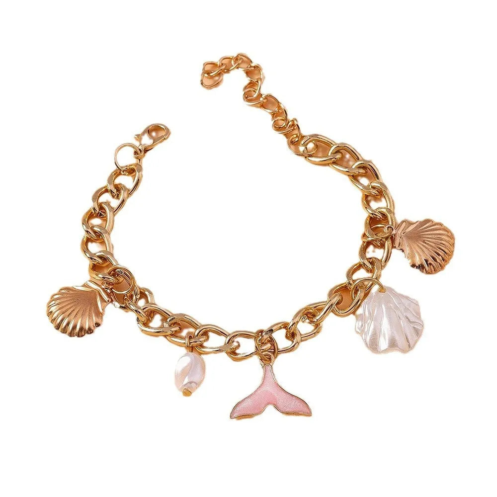 Women's white pearl alloy shell pearl mermaid tail bracelet on neutral background