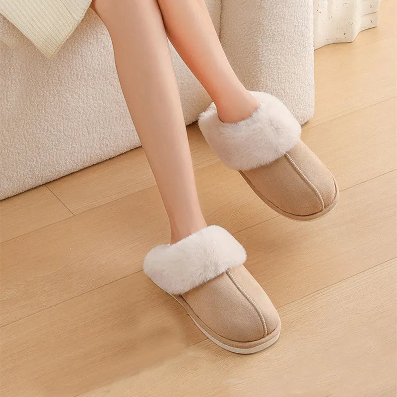 Women's brown plush indoor slippers with round toe, flat heel, and decorative stitching.