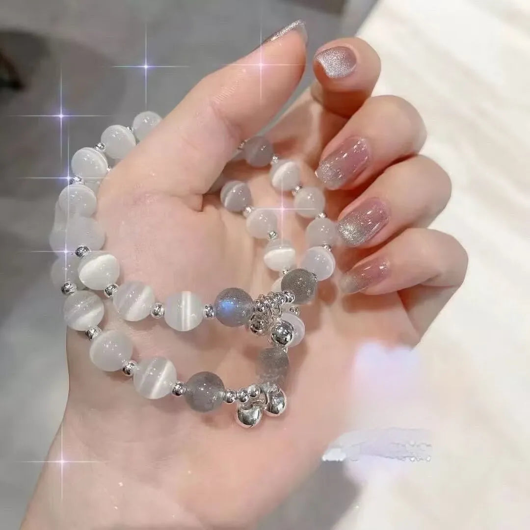 Women's glass butterfly drop-shape bracelet in a grey colourway with round details.