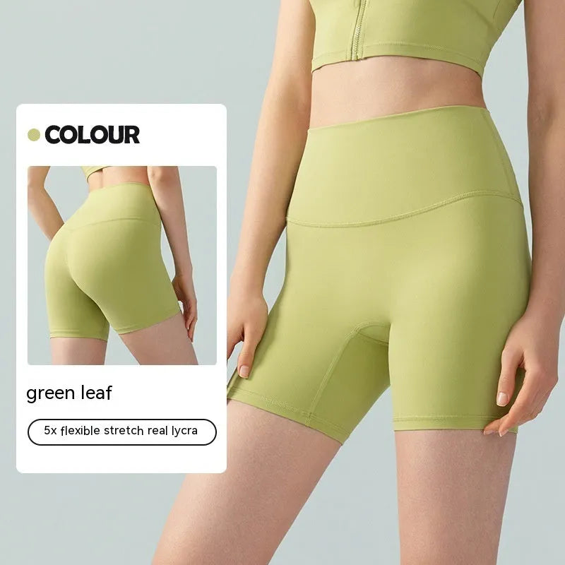 Women's high-waisted Lycra yoga shorts in leaf green, showing anti-exposure construction and short length.