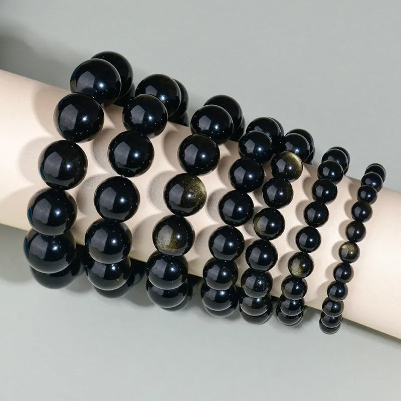 Hand-woven obsidian couple bracelet showing spherical black crystal beads in continuous strand construction