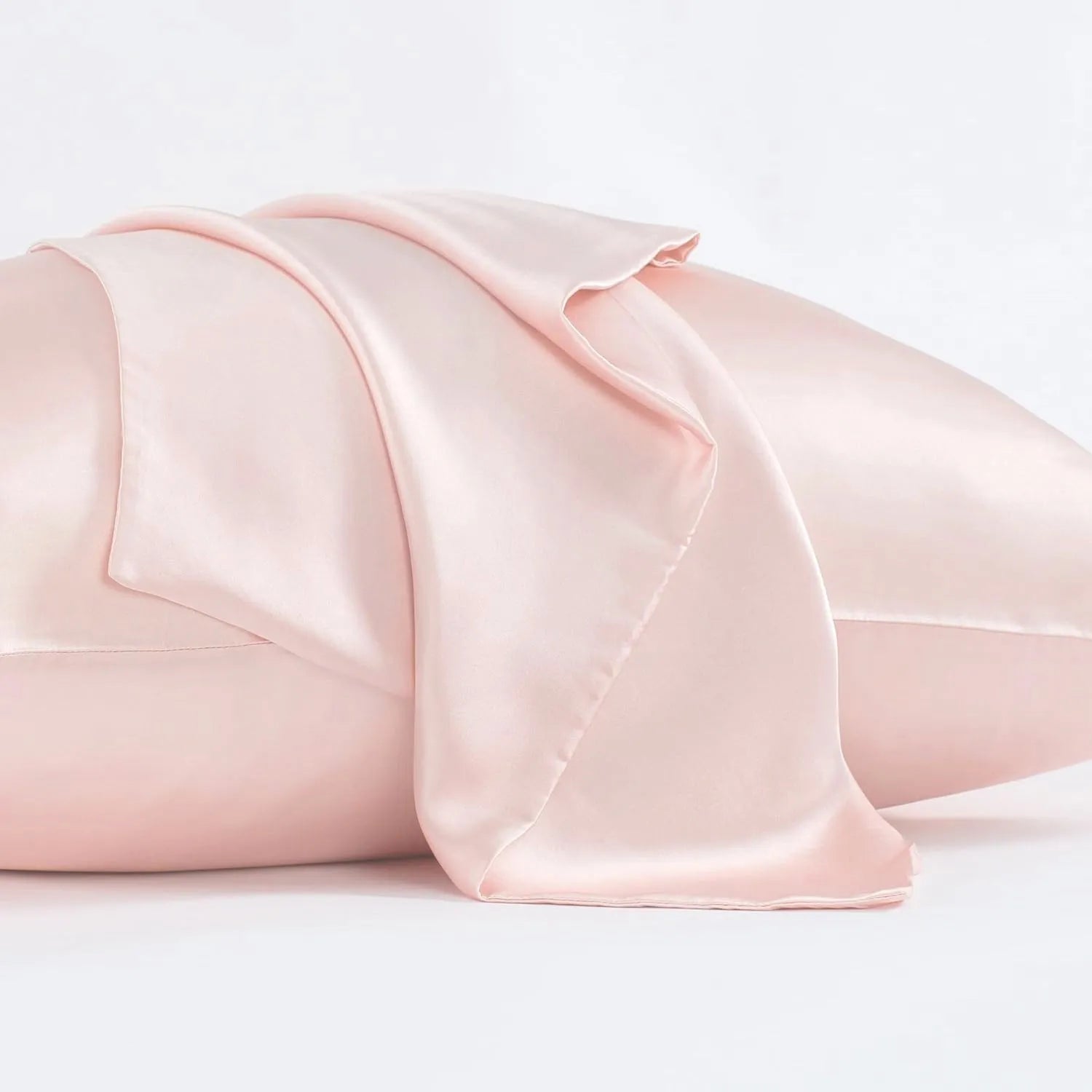 Dark grey silk pillowcase with envelope closure on a bed