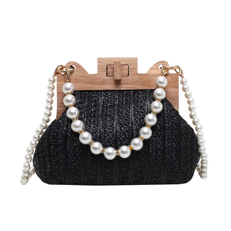 Women's woven straw shoulder bag with pearl chain strap showing interior organiser compartments