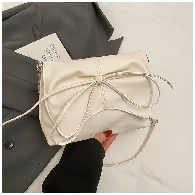 Women's black underarm crossbody bag with visible sewing lines and large capacity design