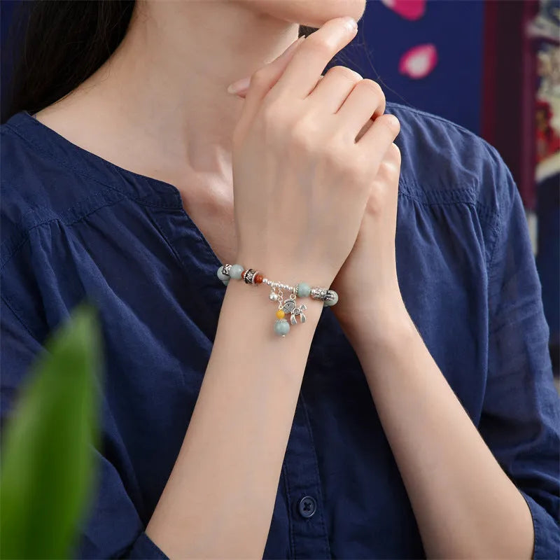 A vintage-style natural jade and alloy metal bracelet bangle for adults, showing retro pony style design.