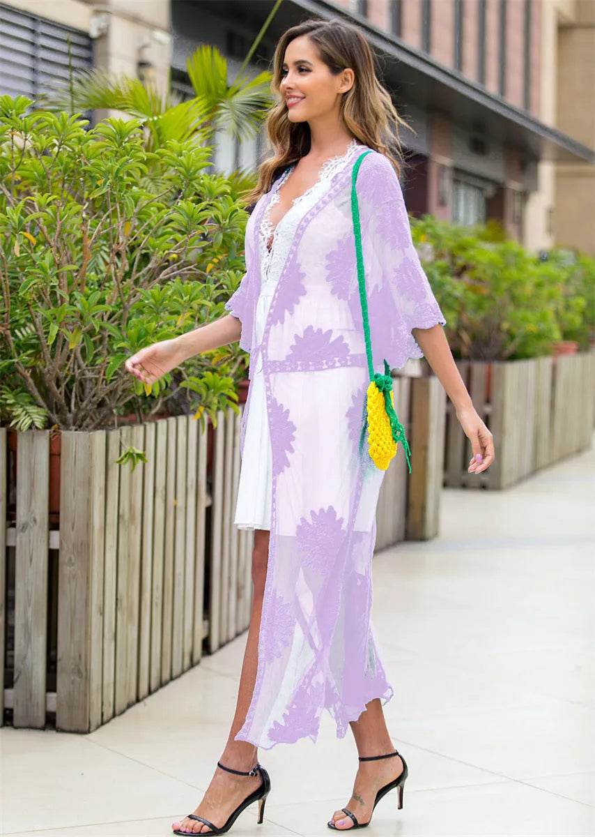 Light purple lace embroidered dress worn as a beach cover-up cardigan.