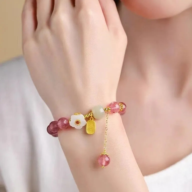 Handcrafted strawberry quartz crystal bracelet with green moon beads and peach blossom Hetian jade charm on adjustable string