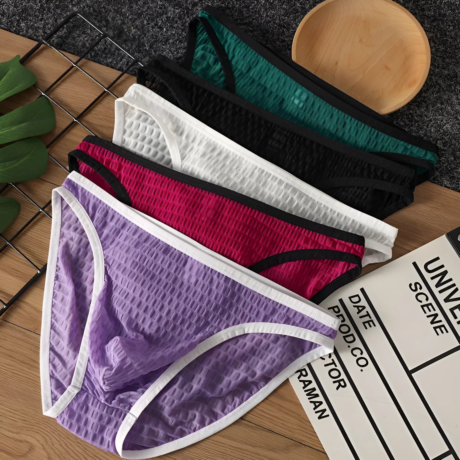 Men's low waist lace underwear shorts in black, showing transparent visual style and lace fabric detail.