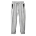 Men's thin leisure tapered knitted pants in black with ankle tie, standing on a neutral background