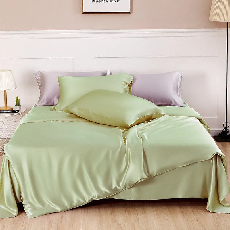 Reversible silk duvet cover folded to show Lotus Pink and pea green sides, with bright brown and silver blue colour swatches.