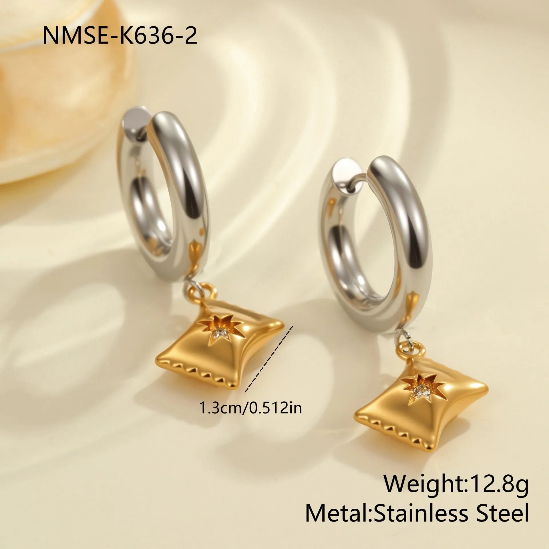 A pair of stainless steel earrings with an 18K gold colour finish, shown in a Christmas tree shape and a heart shape.