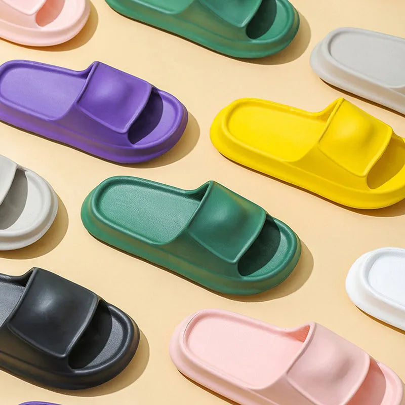 Pair of thick-soled EVA flip flop slippers in purple, showing deep sole profile.