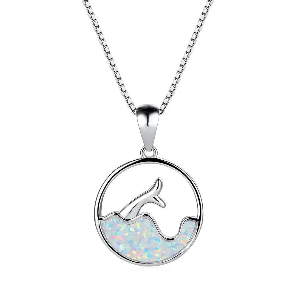 Geometric sea fishtail pendant necklace with a round blue opal stone on a thin chain.