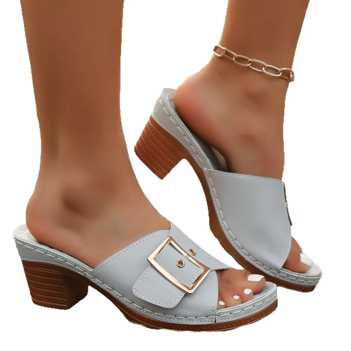Women's black chunky heel slippers with a large silver metal buckle strap on a rubber sole.