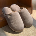 PVC plush winter slippers in solid colours with non-slip soles for indoor wear
