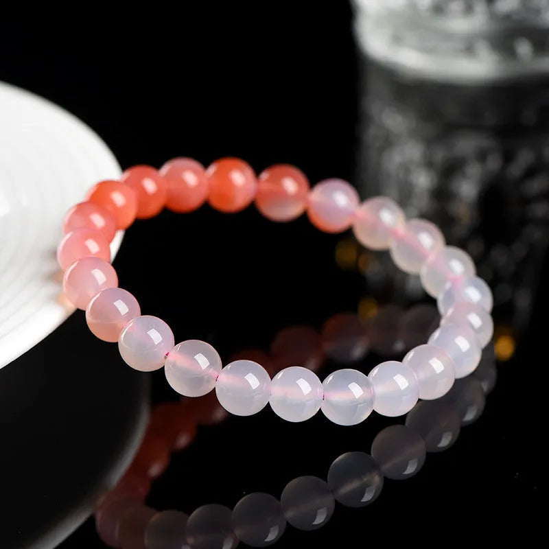 Natural gradient Yanyuan Agate bracelet showing graduated colour on geometrically shaped beads in a single circle.