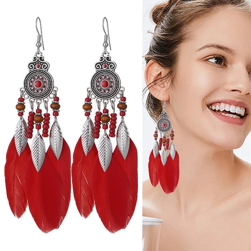 A pair of round drop feather earrings in alloy with Bohemian patterning, shown in one of 14 available colours.