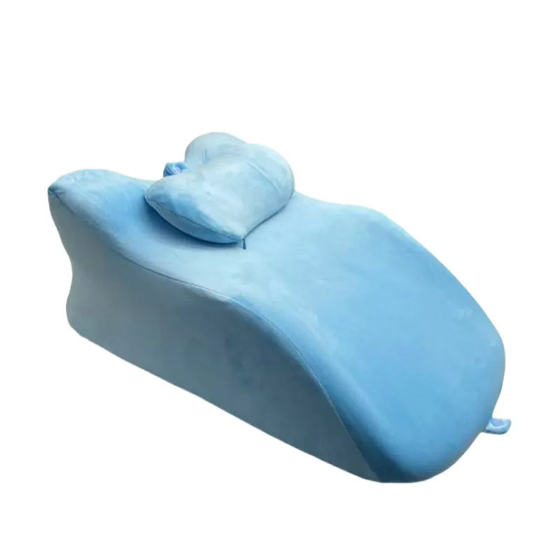 Ergonomic stomach sleeper pillow for reading in bed, shown in blue colour