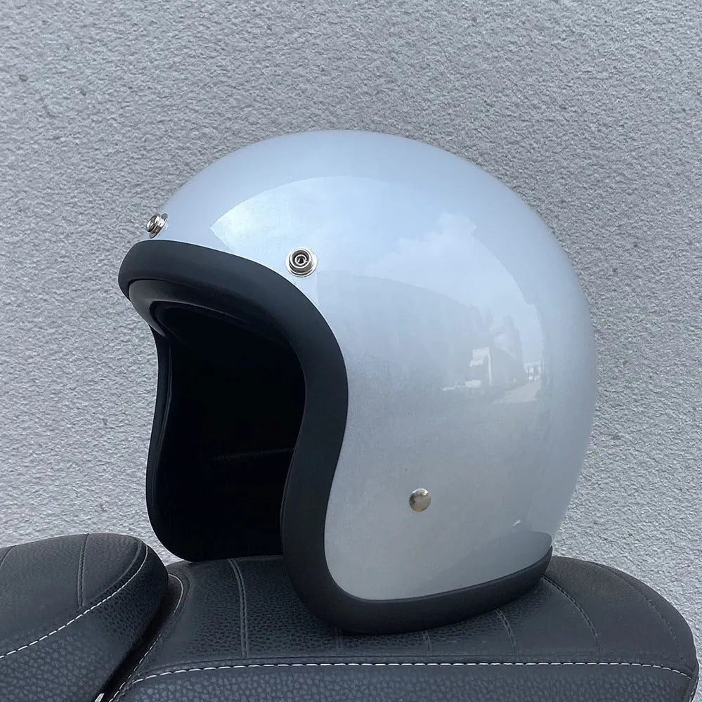 Retro-style half helmet for motorcycles with a fibreglass shell shown in a cement grey colour.