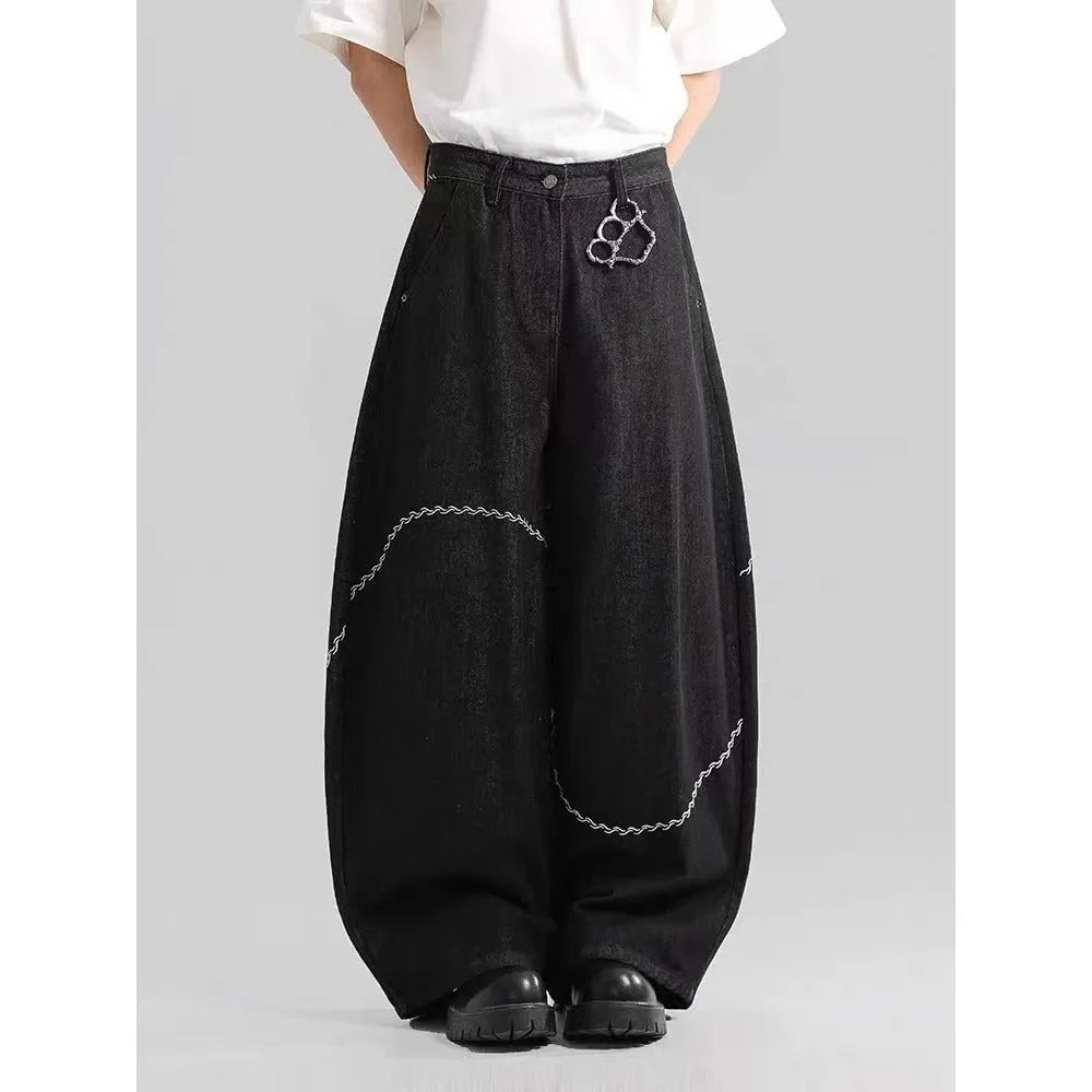 Black straight-leg denim trousers with a mid waist and zip fly, laid flat.