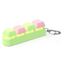 Four-key mechanical keyboard switch tester made of ABS plastic on a desk.
