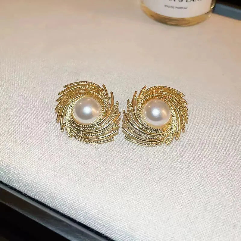 A pair of vintage floral-shaped alloy earrings with a single pearl centre and electroplated finish.
