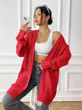 Women's dark green double pocket cardigan with long sleeves and loose fit.