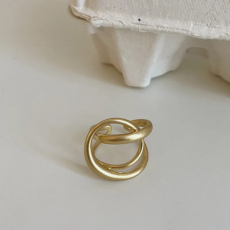 Geometric open ring for women with interlaced matte metal design and real gold plating