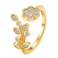 Women's open ring made of copper with a diamond finish, shaped as a detailed flower with leaves, shown in gold and white colour options.