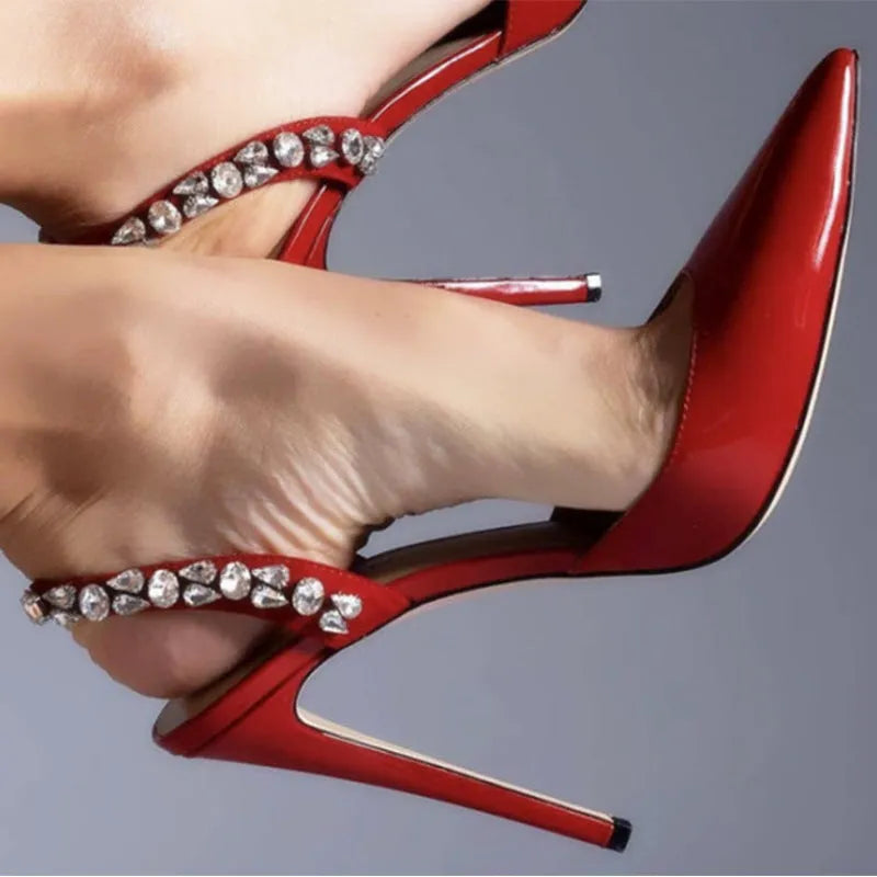 Women's black patent leather rhinestone high heel sandals with pointed toe and ankle strap.