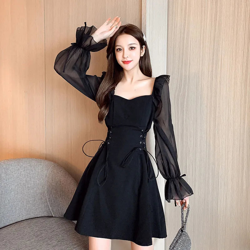 White chiffon patchwork dress with long sleeves and a waist-slimming silhouette on a woman